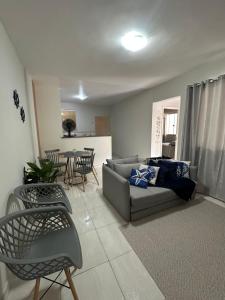 a living room with a couch and a table at Vivendas do Paiol in Guapimirim