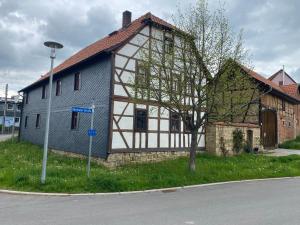 a white and brown house on the side of a street at Schöne Tage im Denkmal in Bittstädt