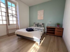 a bedroom with a bed and a dresser in it at Maison en face du Marche Notre-Dame in Poitiers