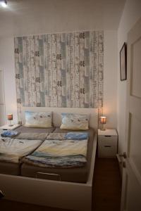 a small bedroom with a bed with a wall with avertisement at Ferienwohnung Labradoodle in Dornum +18 photos
