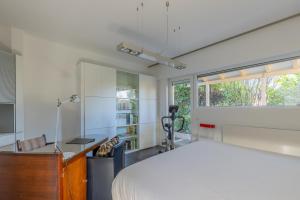 a bedroom with a bed and a desk and a window at Home sweet Lux - 8P - House & garden - 280n m2 in Lorentzweiler