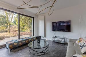 a living room with a couch and a glass table at Home sweet Lux - 8P - House & garden - 280n m2 in Lorentzweiler