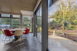 a dining room with a table and chairs and sliding glass doors at Home sweet Lux - 8P - House & garden - 280n m2 in Lorentzweiler