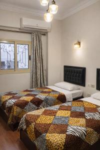 a bedroom with two beds and a window at The New Cairo 3BR Residence in Cairo