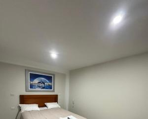 a bedroom with two beds and a painting on the ceiling at Hotel Altavista in Abancay