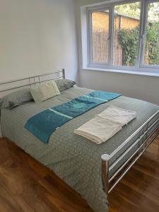 a large bed in a room with a window at Maxismile Haven in Southend-on-Sea