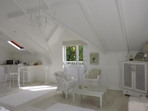 a white room with chairs and a table and a window at Riverlea in Cape Town