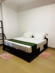 a large bed in a room with two rugs at Sigiriya Yahana in Sigiriya