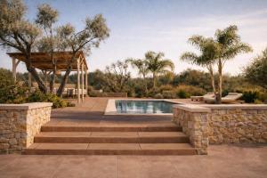 a swimming pool with stairs and a stone wall at Villa Oasis 3 in Kalithies +9 photos