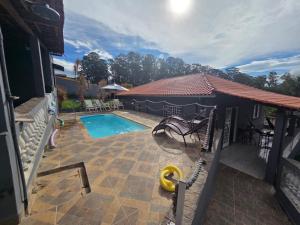 a swimming pool with a slide next to a house at Chacara Recanto Mirella in Socorro +12 photos