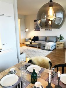 a living room with a table and a couch at Arctic Apartment Rovaniemi in Rovaniemi +14 photos