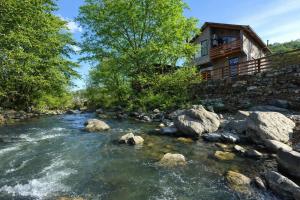 a river in front of a log cabin at Home N 57 in Dilijan