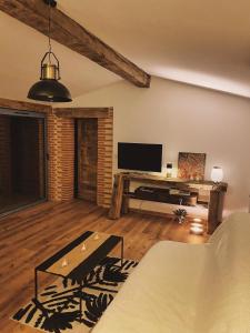a living room with a couch and a flat screen tv at Briques & Bulles in Montauban