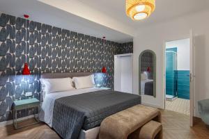 a bedroom with a bed and a wall at Enia Rooms in Nola +19 photos