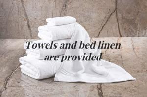 a pile of towels and bed linen are provided at Snowdonia Escape in Trawsfynydd +13 photos