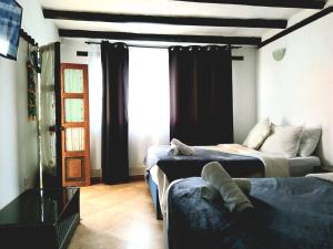 a living room with two beds and a couch at La tranquera hotel in Villa de Leyva