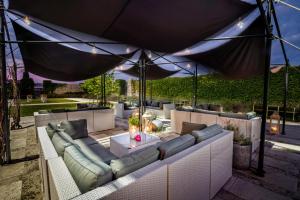 a patio with couches and a table under a tent at Hotel Marcincak*** in Mikulov