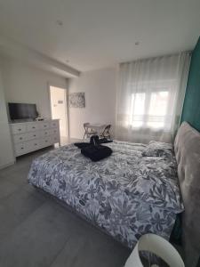 a bedroom with a bed and a dresser and a television at Corte del Gallo in Legnano