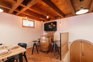 a bar with a wine barrel in a room at Neobyčejný Sklep in Pavlov