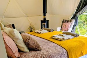 a bedroom with two beds in a tent at Teapot Lane Glamping - Adults only in Sligo +5 photos