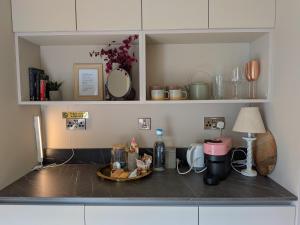 a kitchen counter with a table with a plate of food at Teapot Lane Glamping - Adults only in Sligo