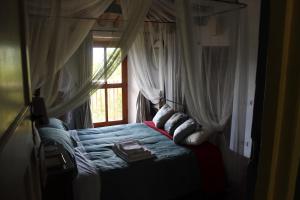 a bedroom with a bed with a window at La Balconata in Bagni di Lucca