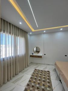 a living room with a large window and a rug at issac in Monastir