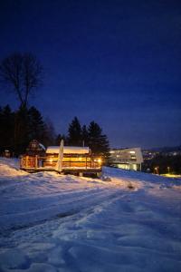 a building is covered in snow at night at Pod Tatrami widok na Tatry, sauna, parking, blisko Term Bukovina in Bukowina Tatrzańska