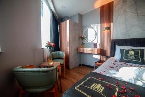 a bedroom with a bed and a chair and a table at Dual Hotel Halkalı in Istanbul