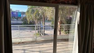 an open window with a view of a street at PALMARES DEL BOULEVARD - Aeropuerto Internacional Taravella - Campus Siglo 21 - Campus Blas Pascal - Sanatorio Allende - Estadio Kempes - Quorum - Mujer Urbana - Complejo Ferial Córdoba in Córdoba