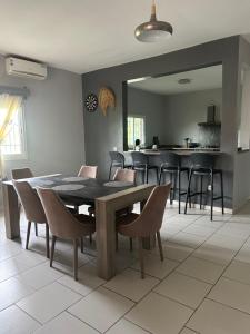 a dining room with a wooden table and chairs at Le Donjon du lycée in Sada