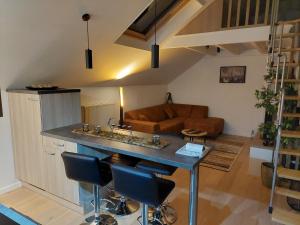 a kitchen and living room with a table and chairs at Aux Caillebotis in Waimes