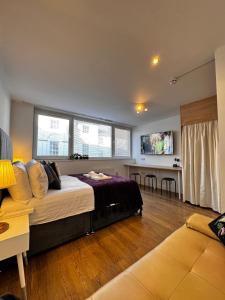 a bedroom with a bed and a living room at Studio with Parking & Shops at Your Door in Andover