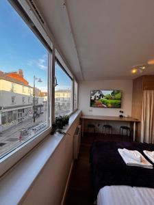 a bedroom with a bed and a large window at Studio with Parking & Shops at Your Door in Andover