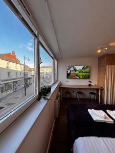 a room with a bed and a large window at Studio with Parking & Shops at Your Door in Andover