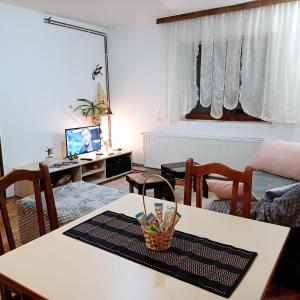 a living room with a table with a basket on it at Sunstation in Šarengrad