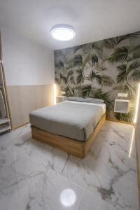 a bedroom with a bed in a room with marble floors at Benidorm Center Playa Poniente in Benidorm