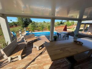a patio with benches and a table and a pool at Tierra Roja in San Vicente