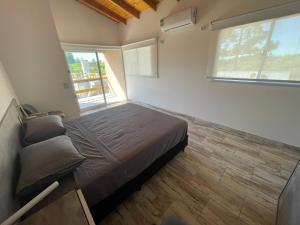 a bedroom with a bed and a large window at Tierra Roja in San Vicente +10 photos