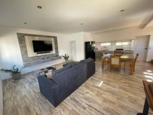 a living room with a couch and a tv on a wall at Tierra Roja in San Vicente