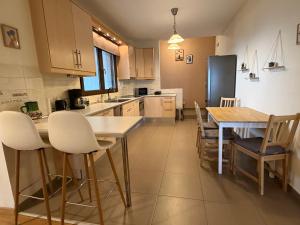 a kitchen with a table and chairs and a refrigerator at The Watch Tower B in Siátista