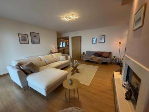 a living room with a white couch and a fireplace at The Watch Tower B in Siátista