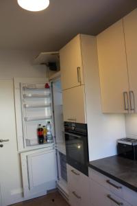 a kitchen with an open refrigerator and a stove at Am Biebricher Schloßpark in Wiesbaden