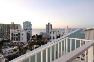 a view of the city from the balcony of a building at Attractive Penthouse in Isla Verde in San Juan