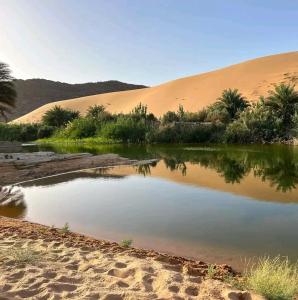 a body of water in the middle of a desert at Auberge Tembahjit in Terjit +55 photos