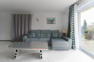 a living room with a couch and a coffee table at Maison Grillon - Maison proche de Vichy avec piscine in Abrest