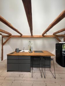 a kitchen with a wooden counter and a sink at Pension Pallini in Geiselwind