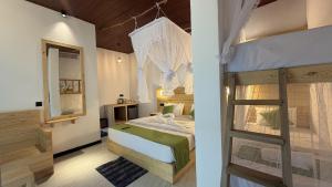 a bedroom with a bunk bed with a ladder at Rawana River Edge in Ella