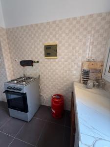a small kitchen with a stove and a counter at Bright Dakar Plateau Apartment in Dakar