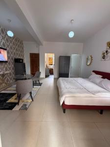 a bedroom with a bed and a table in it at Bright Dakar Plateau Apartment in Dakar